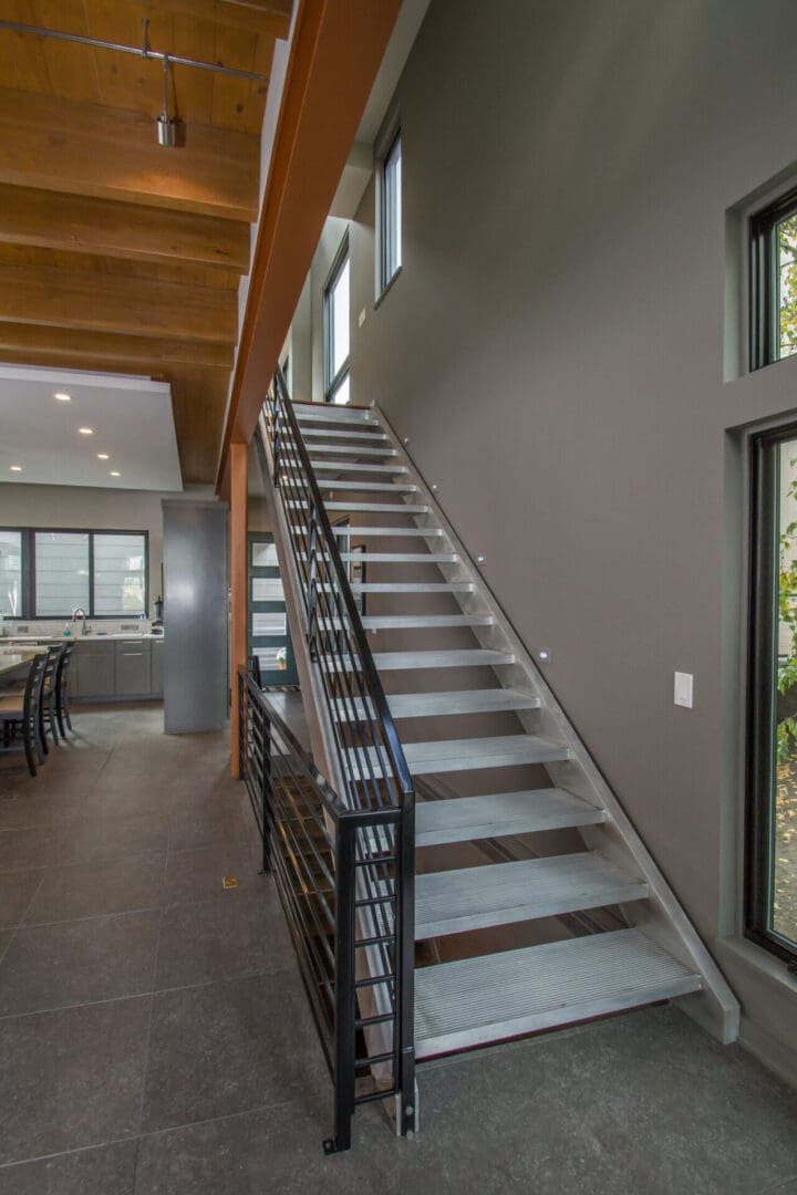 A staircase with metal railing and wood steps.