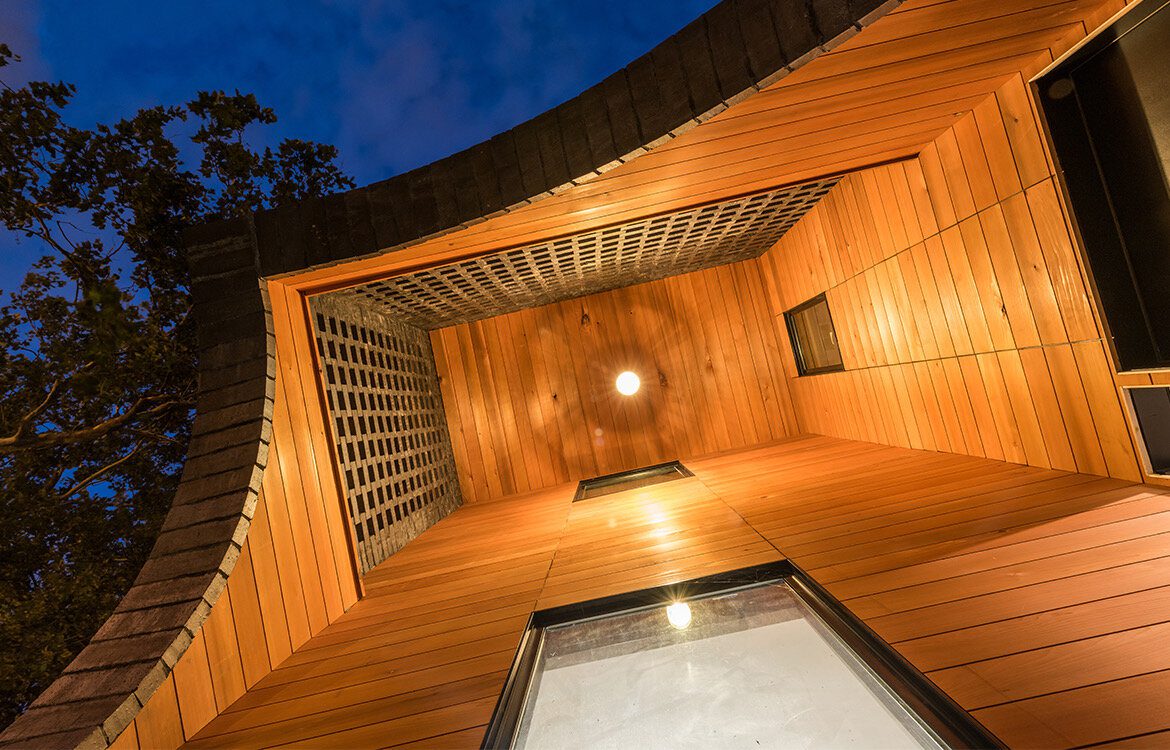 A wooden room with a glass window and a light